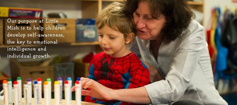 Our purpose at Little Mish is to help children develop self-awareness, the key to emotional intelligence and individual growth. A teacher works with a boy lining up markers.